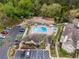 Community pool and amenity area with a hot tub, surrounded by lush trees and landscaping at 625 Greencove Ter # 130, Altamonte Springs, FL 32714