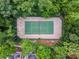 Aerial view of the tennis court surrounded by lush, mature trees at 625 Greencove Ter # 130, Altamonte Springs, FL 32714