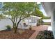 Landscaped backyard featuring a charming pergola with a hot tub, ample seating, and privacy fencing at 625 Worthington Dr, Winter Park, FL 32789