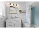 Cozy bathroom with a marble countertop sink, vanity and updated shower at 625 Worthington Dr, Winter Park, FL 32789