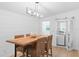 Bright dining room features a modern light fixture and shiplap walls, adding a cozy touch at 625 Worthington Dr, Winter Park, FL 32789