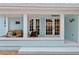 Charming front porch featuring a seating area, coastal decor, and double doors leading into the home at 625 Worthington Dr, Winter Park, FL 32789
