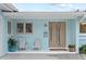 Charming front porch featuring comfortable seating, a decorative front door, and stylish accents at 625 Worthington Dr, Winter Park, FL 32789
