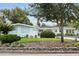 Charming single-story home boasts a well-manicured lawn, mature trees, and stylish mid-century modern architectural features at 625 Worthington Dr, Winter Park, FL 32789