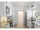 Modern kitchen with stainless steel appliances, sleek white cabinets, and updated countertops at 625 Worthington Dr, Winter Park, FL 32789