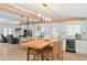 Open-concept kitchen and dining area featuring modern appliances and a built-in wine cooler at 625 Worthington Dr, Winter Park, FL 32789