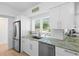 Lovely kitchen area with stainless steel appliances, light countertops, and plenty of natural light at 625 Worthington Dr, Winter Park, FL 32789