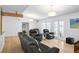 Spacious living room with hardwood floors, modern lighting, and comfortable leather seating at 625 Worthington Dr, Winter Park, FL 32789