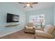 Inviting sitting room with comfortable armchairs, TV, and bright natural lighting at 625 Worthington Dr, Winter Park, FL 32789