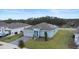 Aerial view of a single-Gathering home showcasing the roof, solar panels, driveway, and surrounding landscape at 663 Fairview Ave, Haines City, FL 33844
