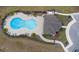 Stunning aerial view of the community pool and clubhouse, surrounded by lush landscaping and inviting lounge chairs at 663 Fairview Ave, Haines City, FL 33844