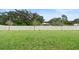 Expansive backyard featuring lush green grass and a tall privacy fence, perfect for outdoor activities at 663 Fairview Ave, Haines City, FL 33844