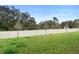 A view of the grassy backyard featuring a tall white fence at 663 Fairview Ave, Haines City, FL 33844