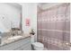 Bathroom featuring granite countertops, a framed art piece, and a shower with curtain at 663 Fairview Ave, Haines City, FL 33844