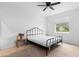 Neutral bedroom with white walls, a ceiling fan, and a black metal bed frame at 663 Fairview Ave, Haines City, FL 33844