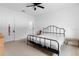 Bright bedroom featuring a ceiling fan, white walls, and a black metal bed frame at 663 Fairview Ave, Haines City, FL 33844