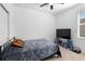 Neutral bedroom featuring a ceiling fan, TV, and stool seats at 663 Fairview Ave, Haines City, FL 33844