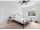 Neutral bedroom with white walls, a ceiling fan, and a black metal bed frame at 663 Fairview Ave, Haines City, FL 33844