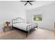 Neutral bedroom with white walls, a ceiling fan, and a black metal bed frame at 663 Fairview Ave, Haines City, FL 33844
