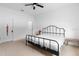 Bright bedroom featuring a ceiling fan, white walls, and a black metal bed frame at 663 Fairview Ave, Haines City, FL 33844