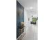 Hallway showcasing modern decor, including a stylish console table, accent wall, and a glimpse into the living area at 663 Fairview Ave, Haines City, FL 33844