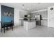 Open kitchen with tile flooring, stainless steel appliances, gray cabinets, and an island at 663 Fairview Ave, Haines City, FL 33844