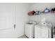 Bright laundry room featuring a door, wire rack and front loading washer and dryer at 663 Fairview Ave, Haines City, FL 33844