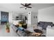 Open-concept living room featuring tile floors, ceiling fan, with a view of the modern kitchen at 663 Fairview Ave, Haines City, FL 33844