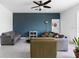 Inviting living room with modern decor, a blue accent wall, and a ceiling fan at 663 Fairview Ave, Haines City, FL 33844