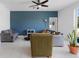 Inviting living room with modern decor, blue accent wall, and a ceiling fan at 663 Fairview Ave, Haines City, FL 33844
