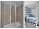 Modern bathroom features a glass shower, tiled walls, and a view of the bedroom at 7419 Marker Ave, Kissimmee, FL 34747