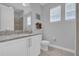 Well-lit bathroom features granite countertops, white cabinets, and tiled floors at 7419 Marker Ave, Kissimmee, FL 34747