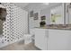 A cute bathroom features a polka dot shower curtain, granite countertops, and decor at 7419 Marker Ave, Kissimmee, FL 34747