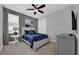 Cozy bedroom featuring a ceiling fan, stylish decor, and comfortable furnishings at 7419 Marker Ave, Kissimmee, FL 34747