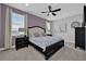 Comfortable bedroom features a ceiling fan, two windows, and a upholstered headboard on the bed at 7419 Marker Ave, Kissimmee, FL 34747