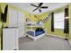 A playful bedroom with a bunk bed, cartoon artwork, and a ceiling fan at 7419 Marker Ave, Kissimmee, FL 34747