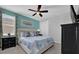 Comfortable bedroom with tufted headboard, ceiling fan, and a large window at 7419 Marker Ave, Kissimmee, FL 34747