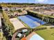 Aerial view of the community amenities including a blue basketball court and volleyball sand court at 7419 Marker Ave, Kissimmee, FL 34747