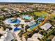 A wide aerial view showcasing water slides, pools, and recreational facilities in a vacation-style community at 7419 Marker Ave, Kissimmee, FL 34747