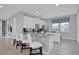 Bright kitchen with granite counters, stainless appliances, and an island with barstool seating at 7419 Marker Ave, Kissimmee, FL 34747