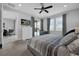 Well-lit main bedroom featuring a gray bed, large windows, and access to a private outdoor space at 7419 Marker Ave, Kissimmee, FL 34747