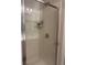 Bathroom shower enclosure with glass doors and chrome fixtures, with shower caddy at 860 N Orange Ave # 470, Orlando, FL 32801