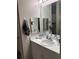 Well-lit bathroom features a white vanity, square mirrors, and updated fixtures at 860 N Orange Ave # 470, Orlando, FL 32801