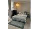 Cozy bedroom featuring a comfortable bed with decorative pillows and a nightstand with a lamp at 860 N Orange Ave # 470, Orlando, FL 32801