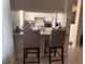 Kitchen pass-through with bar seating, appliances and white cabinetry provides ample cooking space at 860 N Orange Ave # 470, Orlando, FL 32801