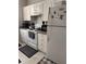 Kitchen with white cabinets, appliances, and granite countertops providing ample cooking space at 860 N Orange Ave # 470, Orlando, FL 32801
