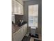 Efficient kitchen with stainless steel sink, white cabinets, and window for natural light and views at 860 N Orange Ave # 470, Orlando, FL 32801