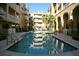 Community pool surrounded by lush landscaping offering a relaxing retreat at 860 N Orange Ave # 470, Orlando, FL 32801