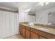 Bathroom with a double sink, granite countertops, vanity, mirror, shower curtain and lighting at 8990 Cuban Palm Rd, Kissimmee, FL 34747