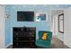 ' bedroom with a TV, chest of drawers, a comfy green chair, and wall art at 8990 Cuban Palm Rd, Kissimmee, FL 34747